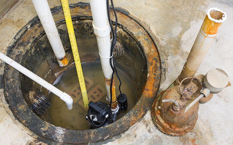 Sump pump in the basement of a home with previous flooding